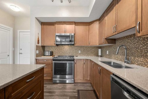 1412-3727 Sage Hill Drive Nw, Calgary, AB - Indoor Photo Showing Kitchen With Stainless Steel Kitchen With Double Sink With Upgraded Kitchen