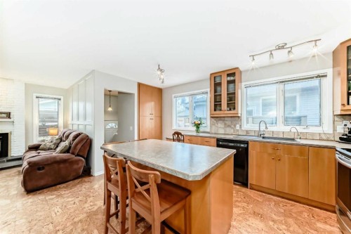 308 Cannington Place Sw, Calgary, AB - Indoor Photo Showing Kitchen With Fireplace With Double Sink