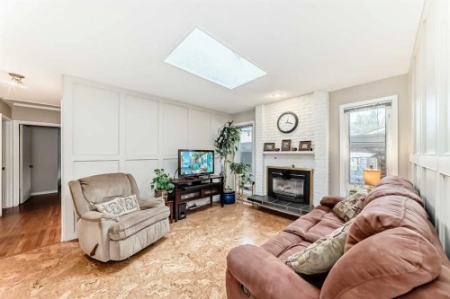 308 Cannington Place Sw, Calgary, AB - Indoor Photo Showing Living Room With Fireplace