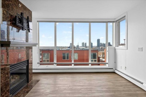 404-603 7 Avenue Ne, Calgary, AB - Indoor Photo Showing Living Room With Fireplace