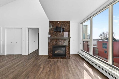 404-603 7 Avenue Ne, Calgary, AB - Indoor Photo Showing Living Room With Fireplace