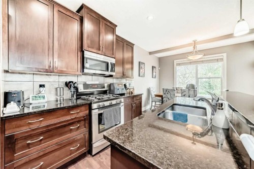 228 Cranston Drive Se, Calgary, AB - Indoor Photo Showing Kitchen With Double Sink