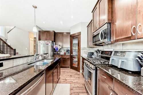 228 Cranston Drive Se, Calgary, AB - Indoor Photo Showing Kitchen With Stainless Steel Kitchen With Double Sink With Upgraded Kitchen