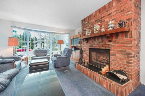 3623 54 Avenue Sw, Calgary, AB - Indoor Photo Showing Living Room With Fireplace