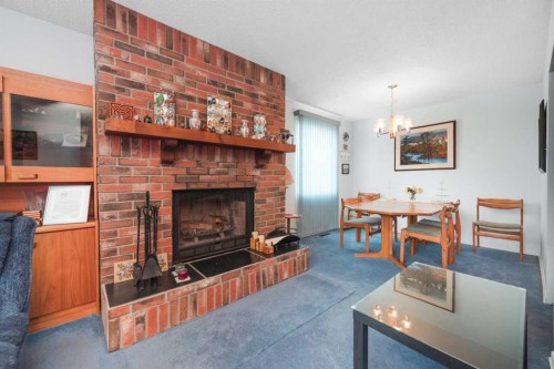 3623 54 Avenue Sw, Calgary, AB - Indoor Photo Showing Living Room With Fireplace