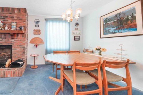 3623 54 Avenue Sw, Calgary, AB - Indoor Photo Showing Dining Room With Fireplace