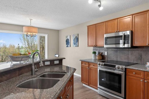 130 Morningside Point Sw, Airdrie, AB - Indoor Photo Showing Kitchen With Double Sink