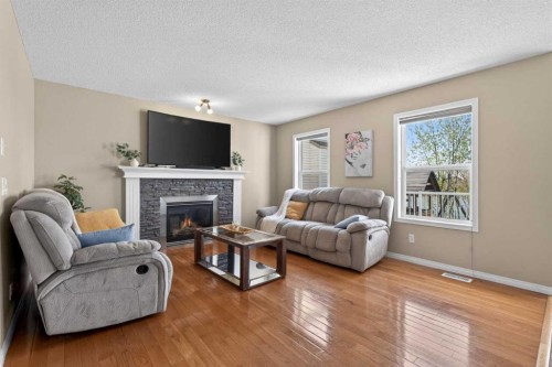 130 Morningside Point Sw, Airdrie, AB - Indoor Photo Showing Living Room With Fireplace