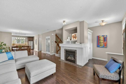44 Mike Ralph Way Sw, Calgary, AB - Indoor Photo Showing Living Room With Fireplace