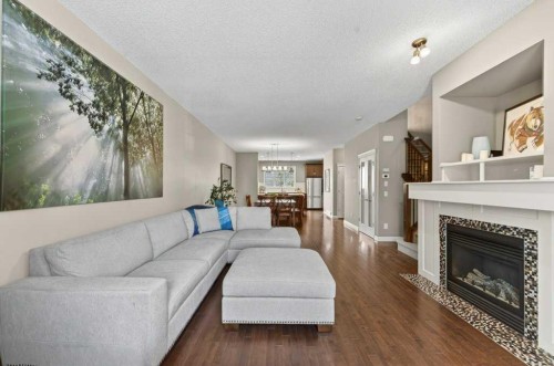 44 Mike Ralph Way Sw, Calgary, AB - Indoor Photo Showing Living Room With Fireplace