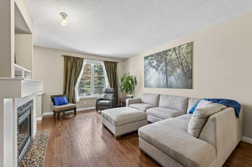 44 Mike Ralph Way Sw, Calgary, AB - Indoor Photo Showing Living Room With Fireplace