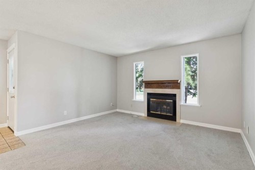 923 Midridge Drive Se, Calgary, AB - Indoor Photo Showing Living Room With Fireplace