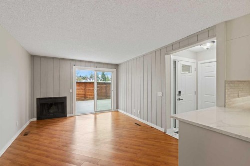 1402-13104 Elbow Drive Sw, Calgary, AB - Indoor Photo Showing Living Room With Fireplace