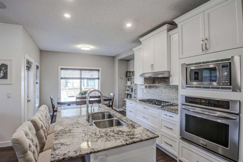 29 Drake Landing Loop, Okotoks, AB - Indoor Photo Showing Kitchen With Stainless Steel Kitchen With Double Sink With Upgraded Kitchen