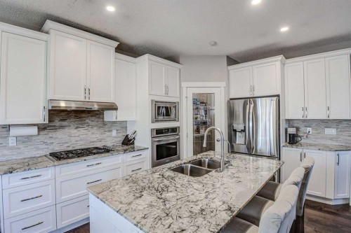 29 Drake Landing Loop, Okotoks, AB - Indoor Photo Showing Kitchen With Stainless Steel Kitchen With Double Sink With Upgraded Kitchen