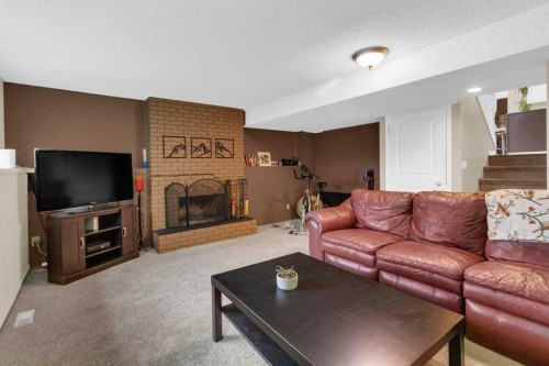 52 Strathclair Rise Sw, Calgary, AB - Indoor Photo Showing Living Room With Fireplace