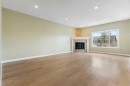 175 Sunset Close, Cochrane, AB  - Indoor Photo Showing Living Room With Fireplace 