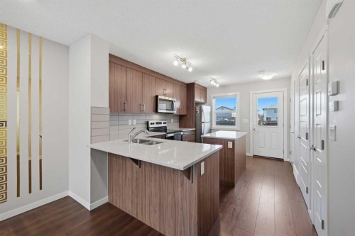 1322-7451 Falconridge Boulevard Ne, Calgary, AB - Indoor Photo Showing Kitchen With Double Sink