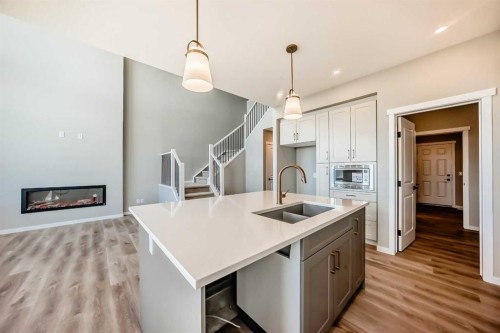 103 Mercado Crescent Se, Calgary, AB - Indoor Photo Showing Kitchen With Fireplace With Double Sink With Upgraded Kitchen