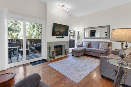 111 Point Drive Nw, Calgary, AB - Indoor Photo Showing Living Room With Fireplace