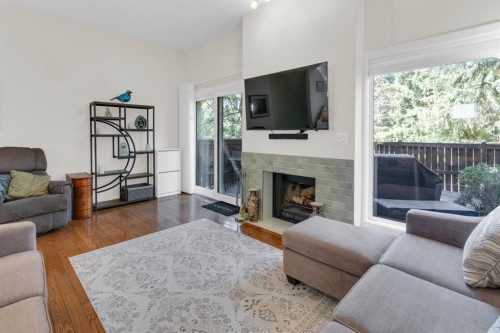 111 Point Drive Nw, Calgary, AB - Indoor Photo Showing Living Room With Fireplace