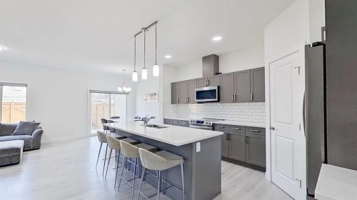 55 Belgian Crescent, Cochrane, AB - Indoor Photo Showing Kitchen With Upgraded Kitchen