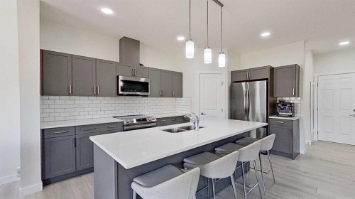 55 Belgian Crescent, Cochrane, AB - Indoor Photo Showing Kitchen With Double Sink With Upgraded Kitchen