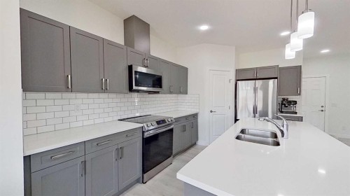 55 Belgian Crescent, Cochrane, AB - Indoor Photo Showing Kitchen With Double Sink With Upgraded Kitchen