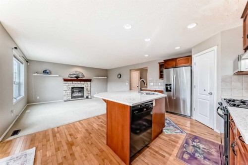 80 Eversyde Way Sw, Calgary, AB - Indoor Photo Showing Kitchen With Fireplace