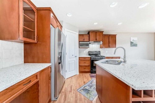 80 Eversyde Way Sw, Calgary, AB - Indoor Photo Showing Kitchen With Double Sink