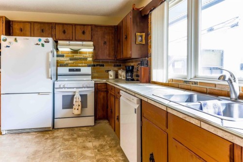 1444 Acadia Drive Se, Calgary, AB - Indoor Photo Showing Kitchen With Double Sink