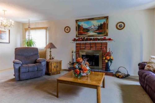 1444 Acadia Drive Se, Calgary, AB - Indoor Photo Showing Living Room With Fireplace