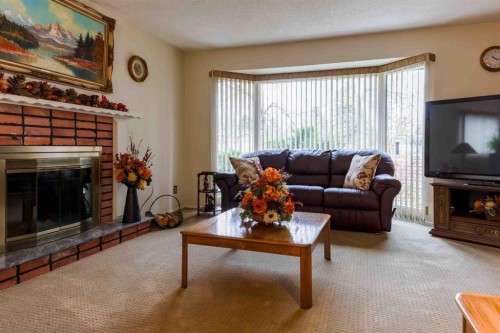 1444 Acadia Drive Se, Calgary, AB - Indoor Photo Showing Living Room With Fireplace