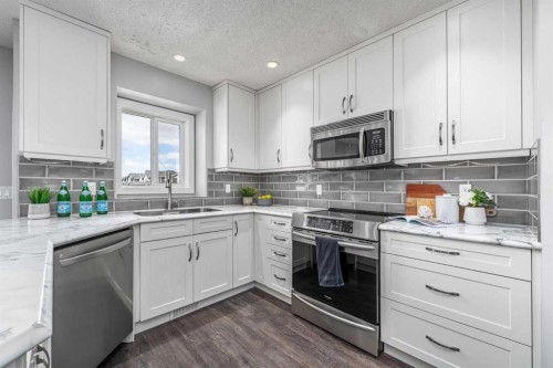 724 Luxstone Landing Sw, Airdrie, AB - Indoor Photo Showing Kitchen With Upgraded Kitchen