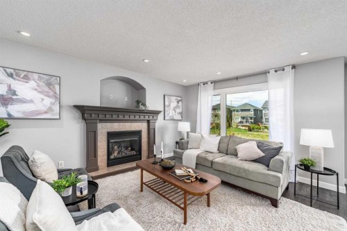 724 Luxstone Landing Sw, Airdrie, AB - Indoor Photo Showing Living Room With Fireplace