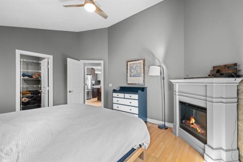 91 Evanspark Terrace Nw, Calgary, AB - Indoor Photo Showing Bedroom With Fireplace
