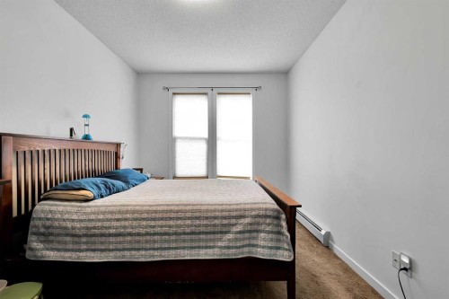 224-207 Sunset Drive, Cochrane, AB - Indoor Photo Showing Bedroom