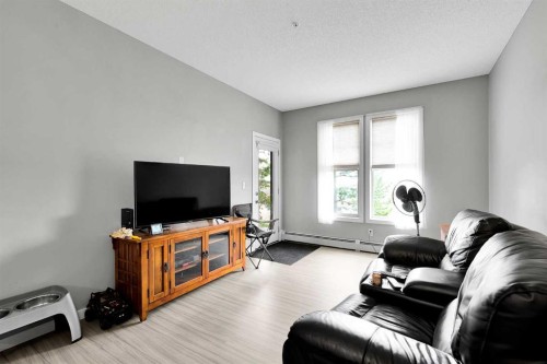 224-207 Sunset Drive, Cochrane, AB - Indoor Photo Showing Living Room