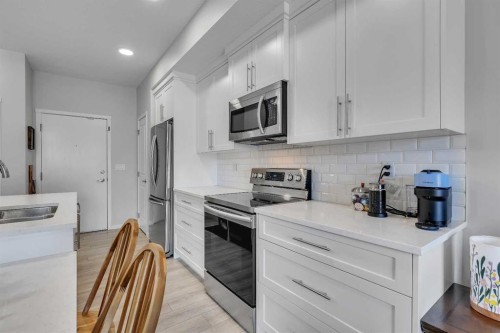 206-370 Harvest Hills Common Ne, Calgary, AB - Indoor Photo Showing Kitchen With Stainless Steel Kitchen