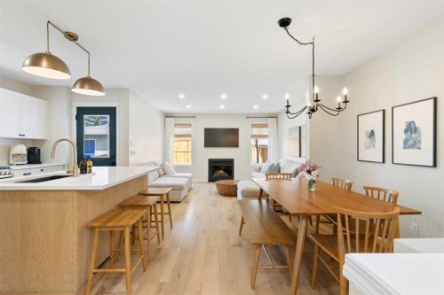 89 Tuscany Springs Heights Nw, Calgary, AB - Indoor Photo Showing Dining Room With Fireplace