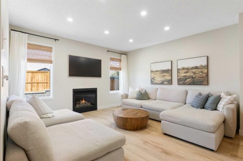 89 Tuscany Springs Heights Nw, Calgary, AB - Indoor Photo Showing Living Room With Fireplace
