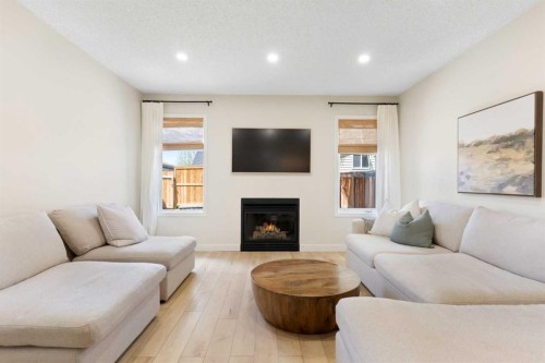 89 Tuscany Springs Heights Nw, Calgary, AB - Indoor Photo Showing Living Room With Fireplace