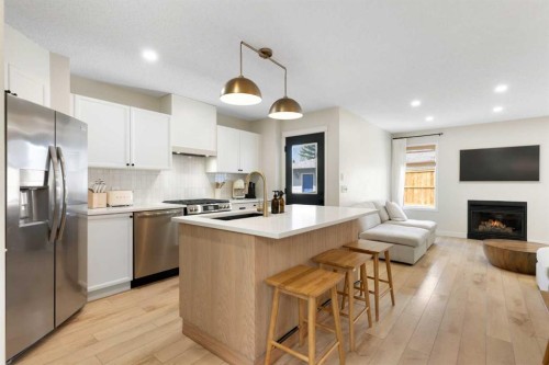 89 Tuscany Springs Heights Nw, Calgary, AB - Indoor Photo Showing Kitchen With Fireplace With Upgraded Kitchen