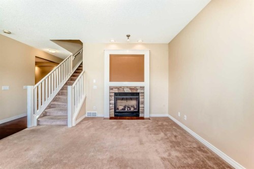 22 Everhollow Rise Sw, Calgary, AB - Indoor Photo Showing Other Room With Fireplace
