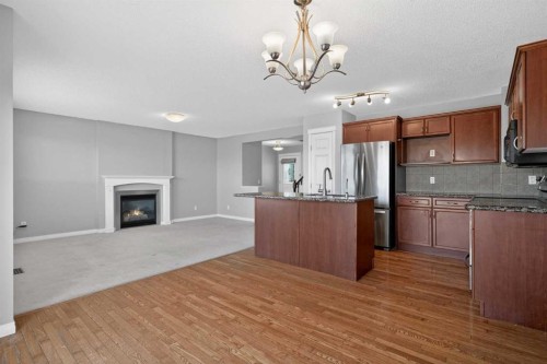 124 Everglen Way Sw, Calgary, AB - Indoor Photo Showing Kitchen With Fireplace