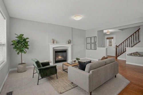 124 Everglen Way Sw, Calgary, AB - Indoor Photo Showing Living Room With Fireplace