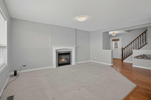 124 Everglen Way Sw, Calgary, AB - Indoor Photo Showing Living Room With Fireplace