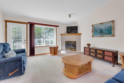 104 Whispering Way, Vulcan, AB - Indoor Photo Showing Living Room With Fireplace