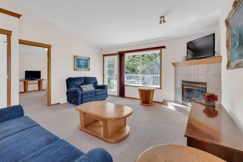 104 Whispering Way, Vulcan, AB - Indoor Photo Showing Living Room With Fireplace