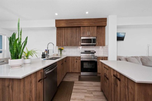 203-33 Merganser Drive, Chestermere, AB - Indoor Photo Showing Kitchen With Stainless Steel Kitchen With Double Sink With Upgraded Kitchen